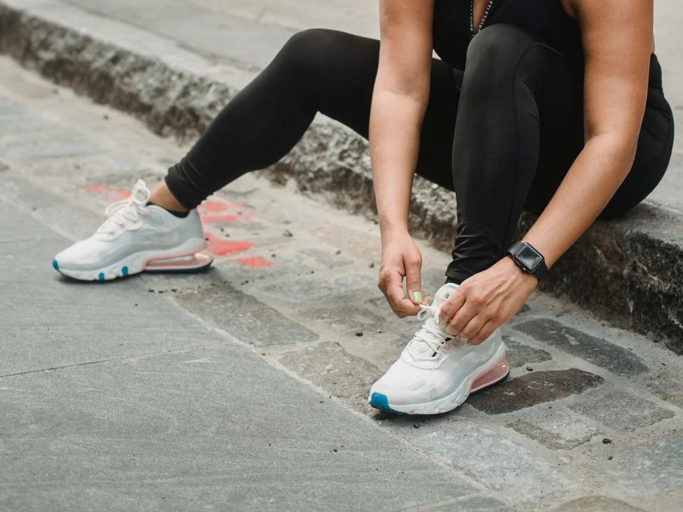 Hands tying walking shoes outdoors