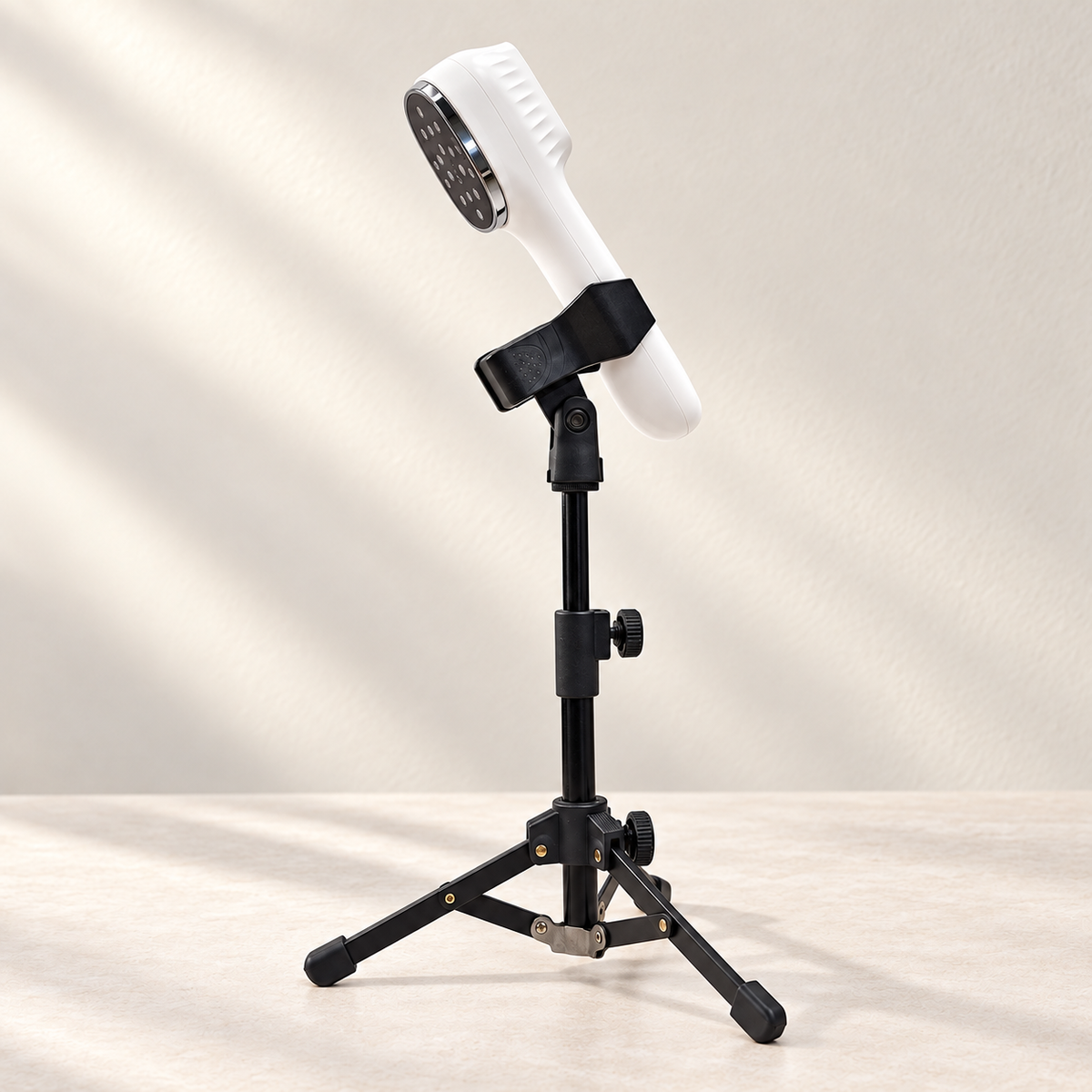 SISSILUX handheld laser secured in the included holder on its adjustable tripod stand.